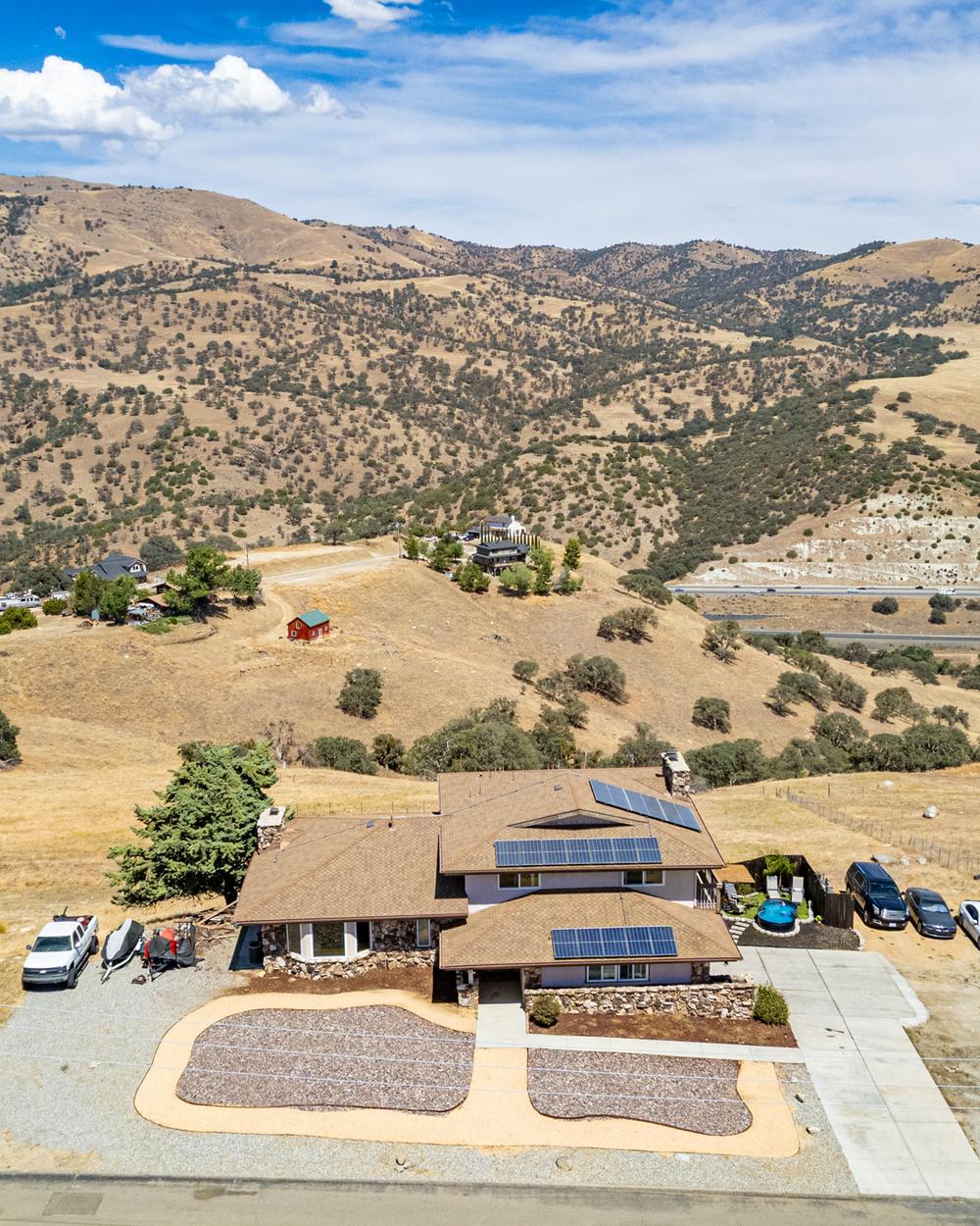 Drone photograph of a Tehachapi-area home on golden hillside acreage — an example of Sarah's listing marketing