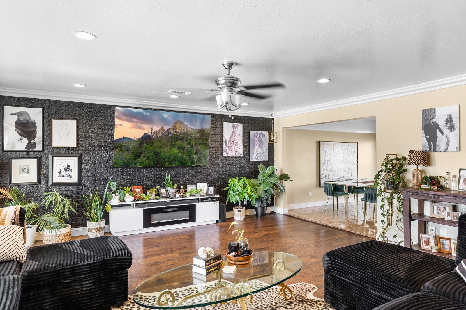 Living room media accent wall opening to the dining area and its mountain-view windows