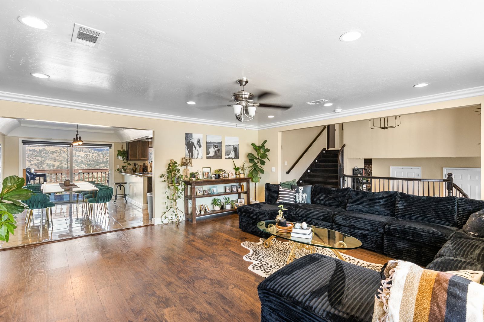 Open living area flowing into the dining space and kitchen, with the split-level staircase beyond