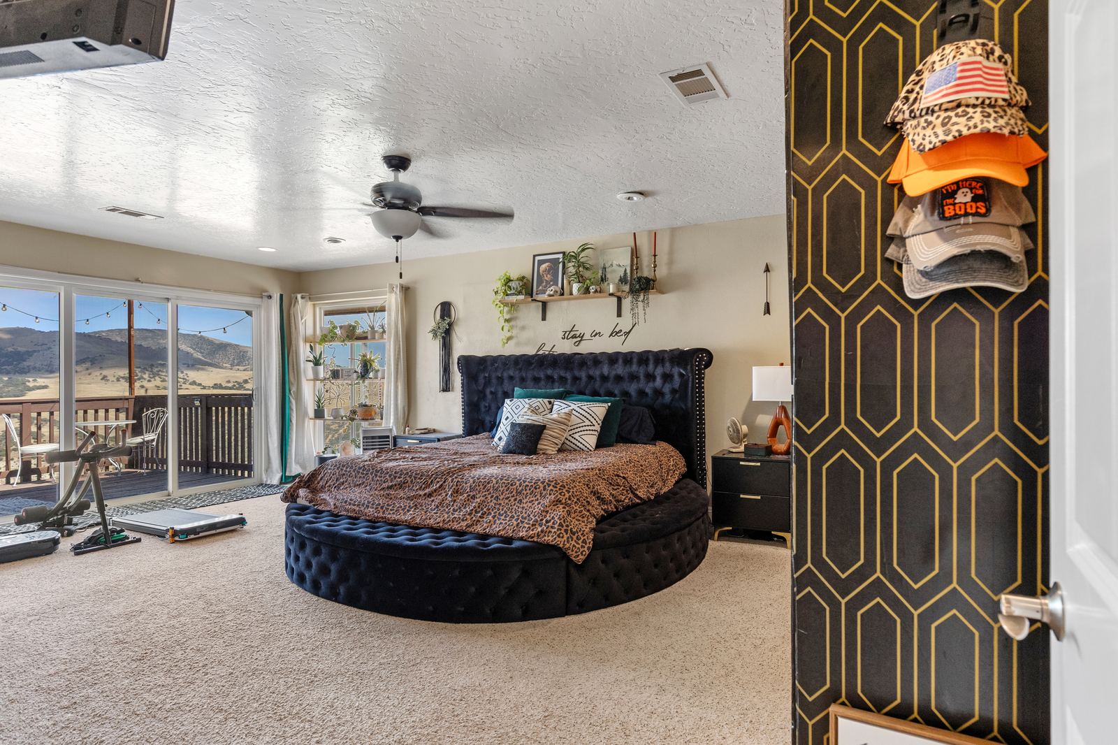 Primary suite with a slider to its private view deck and mountain views beyond